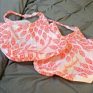Set of 2 FP Movement by Free People pink & neon orange sling Bag